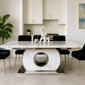 Ether dining table with a white marble top and circular pedestal base in stainless steel, styled in a modern dining room