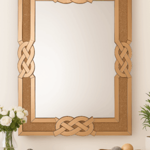 Luxury tawny rose gold wall mirror with glittering frame and Celtic knot accents, styled with decor accessories from SKM Furniture Perth